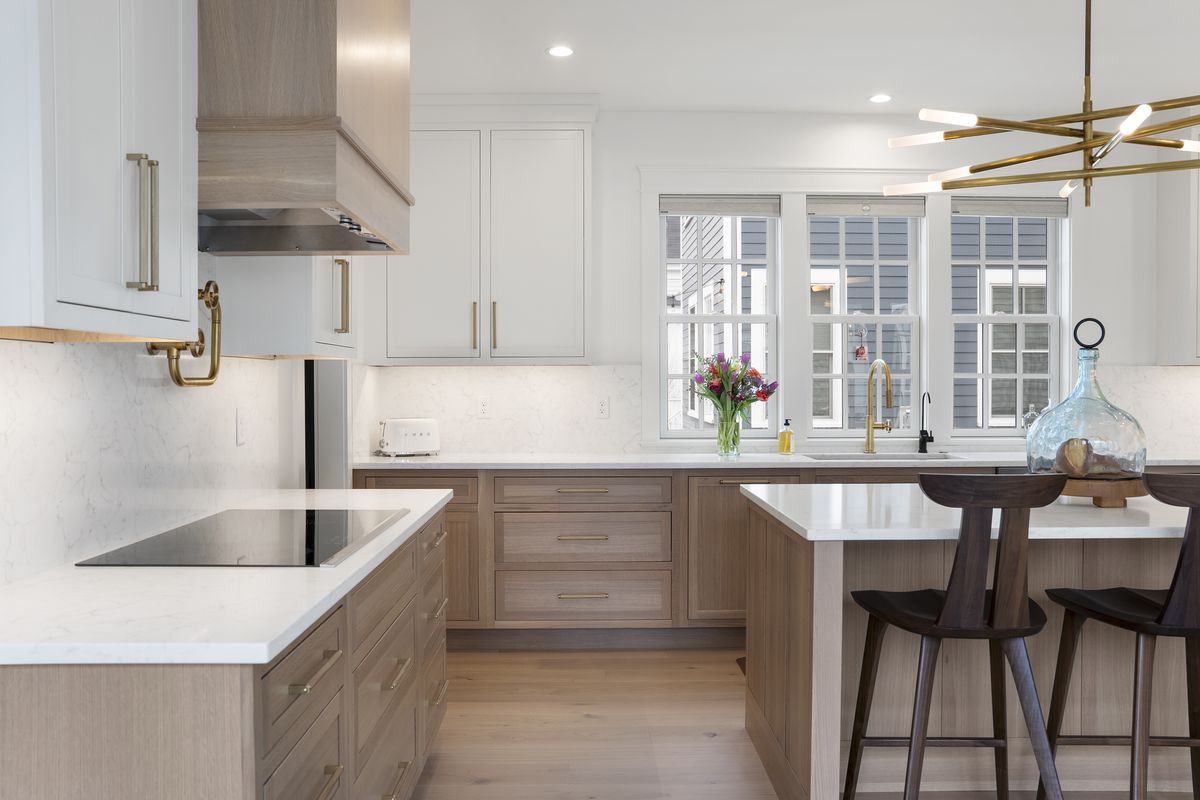 Custom wood range hood above a cooktop in a Scarborough, Maine custom kitchen