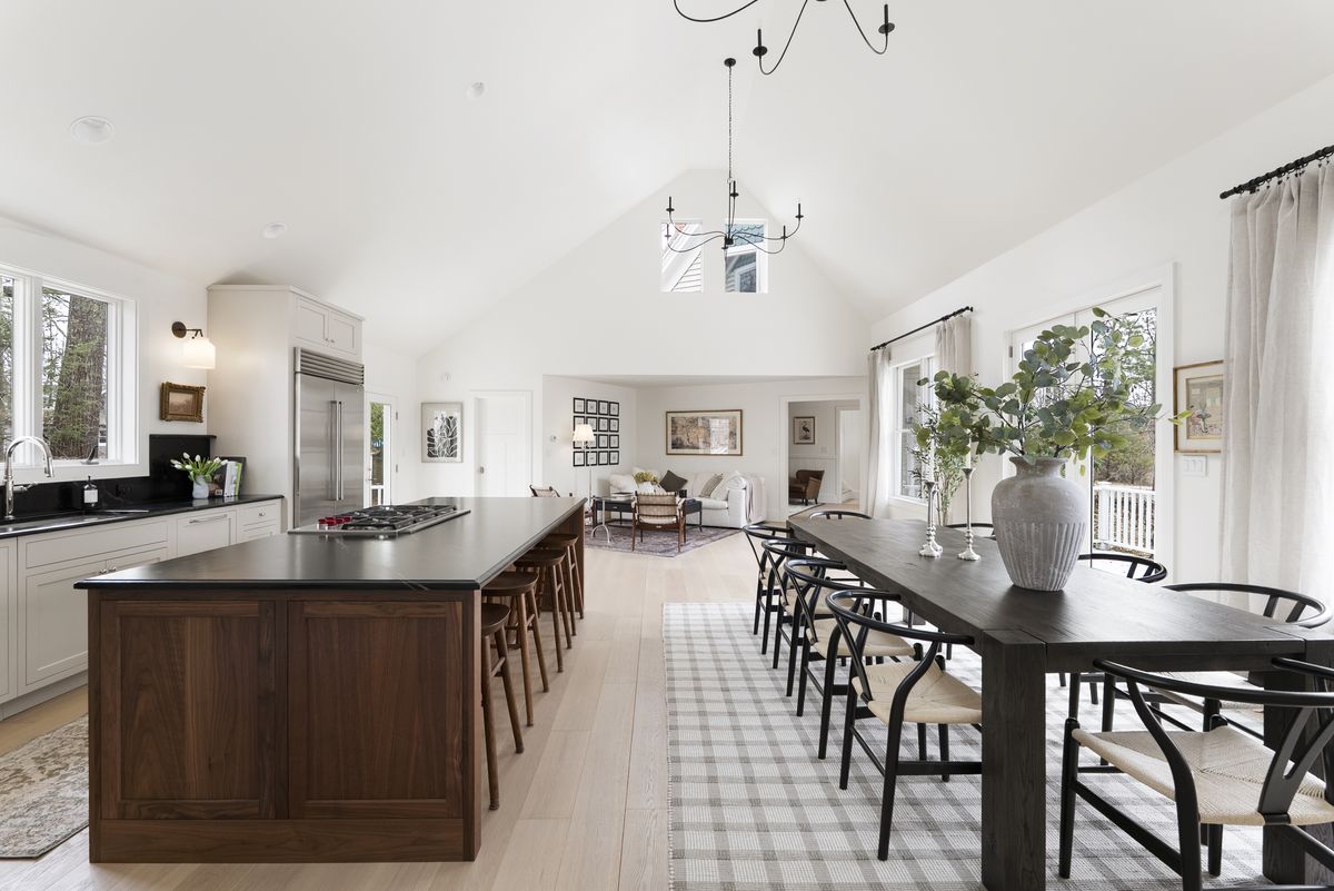 Long view from custom kitchen through dining area with cathedral ceiling in a Yarmouth, Maine home