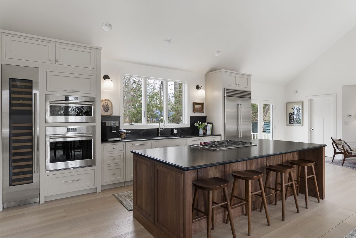 Integrated wall ovens and wine column in painted perimeter cabinetry in a Yarmouth, Maine kitchen