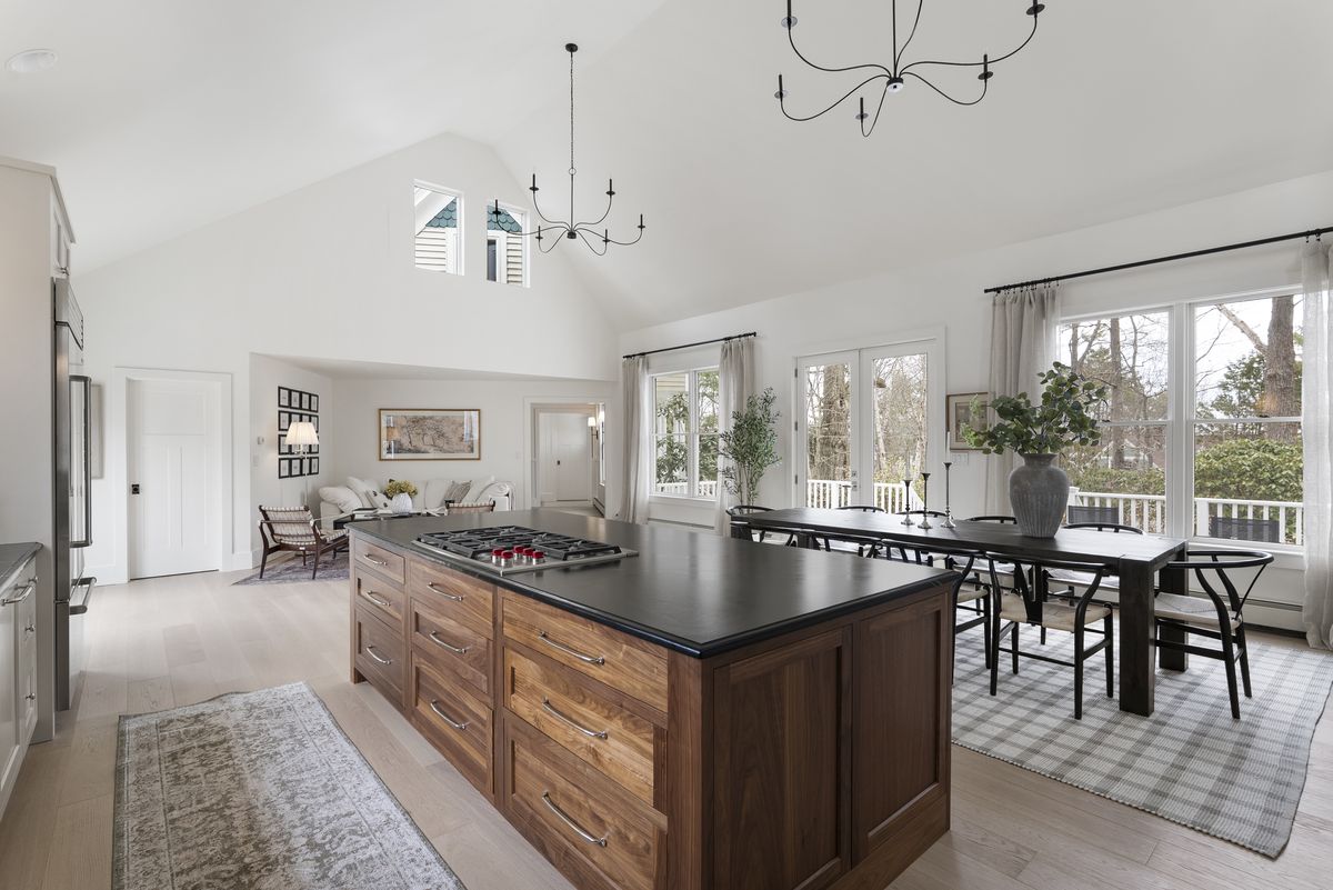 Open plan custom kitchen and dining area under a vaulted ceiling in Yarmouth, Maine